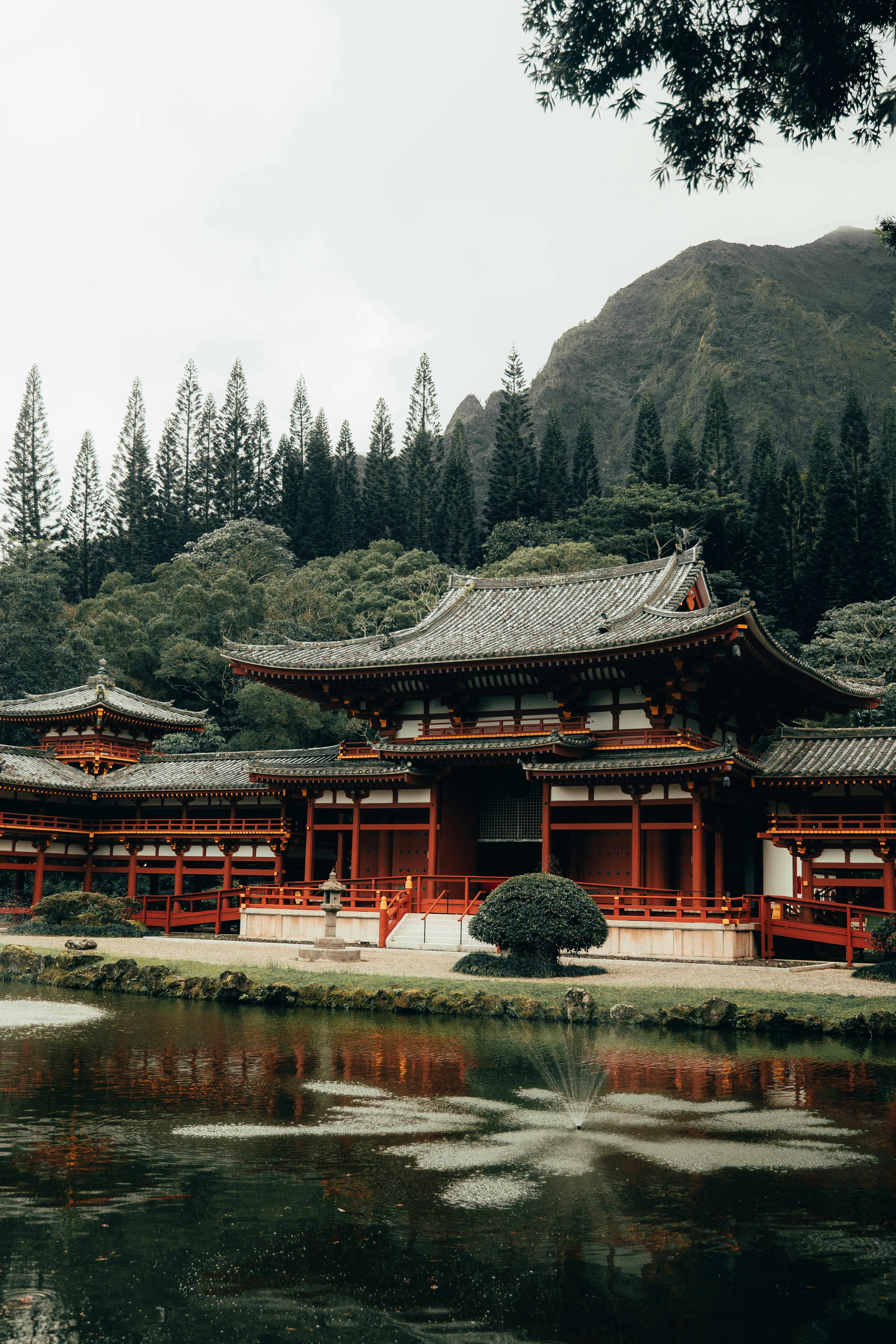 red and black temple near lake